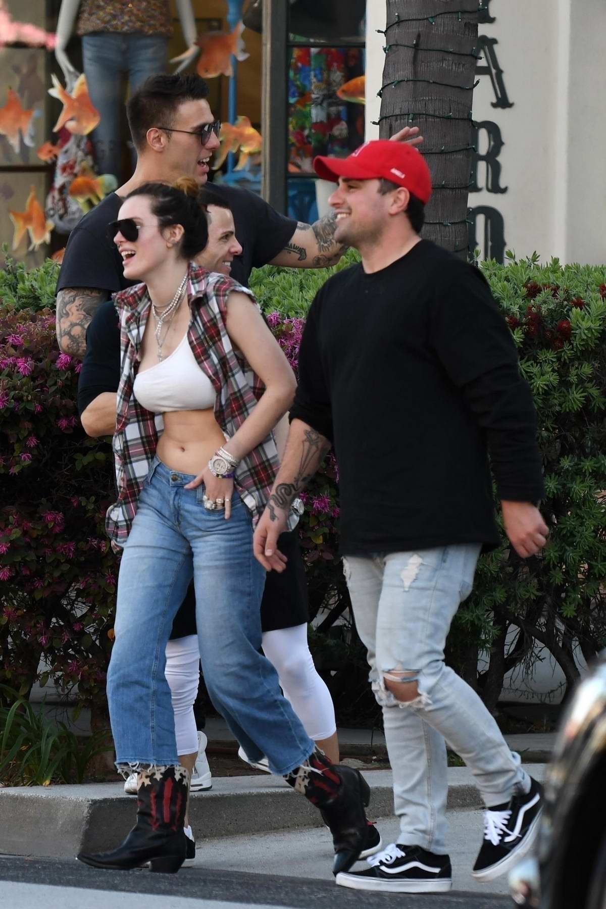 Bella Thorne Flashes Her Toned Midriff In A White Crop Top While Out Grabbing Lunch With Friends