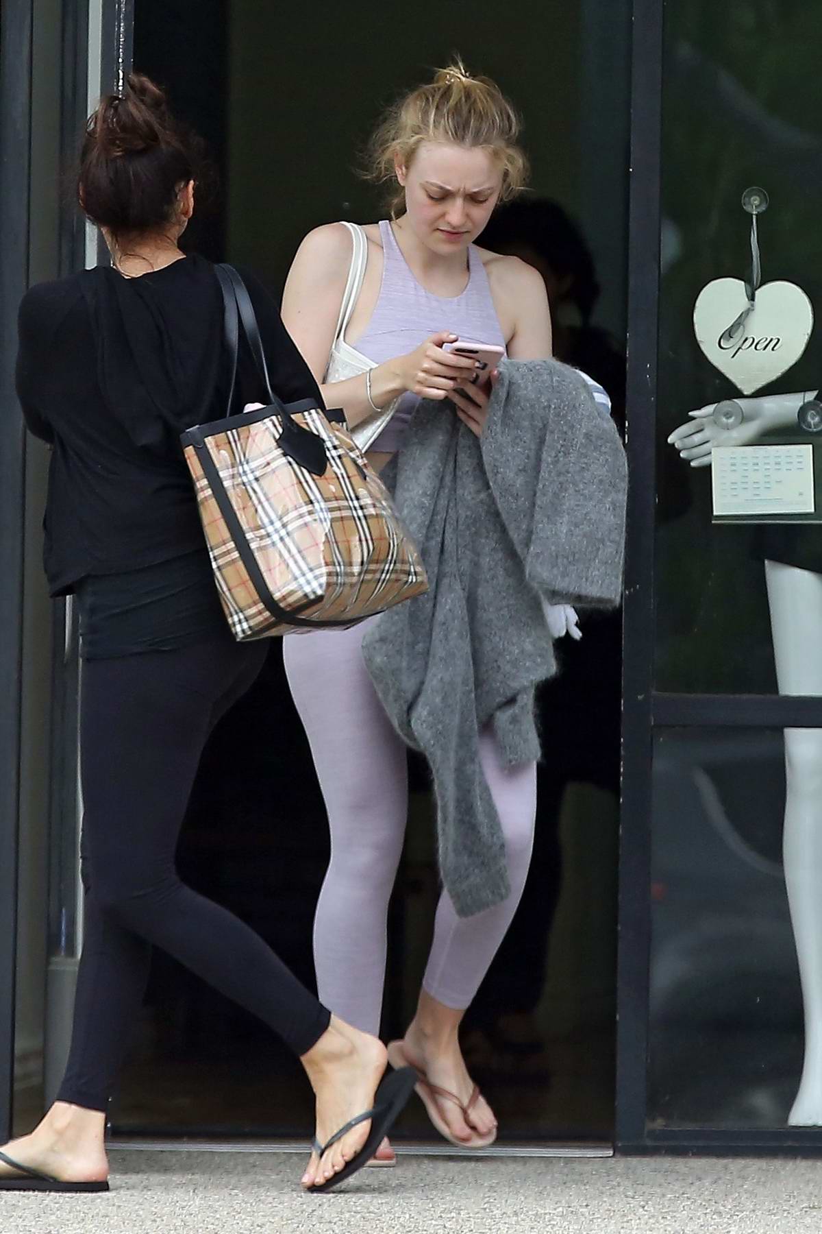 Dakota Fanning seen with her Louis Vuitton suitcase as she leaves