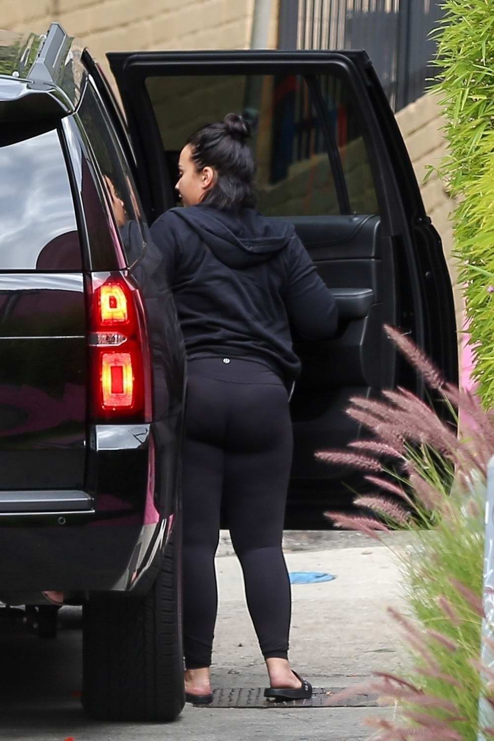 Demi Lovato spotted in a black hoodie with matching leggings as