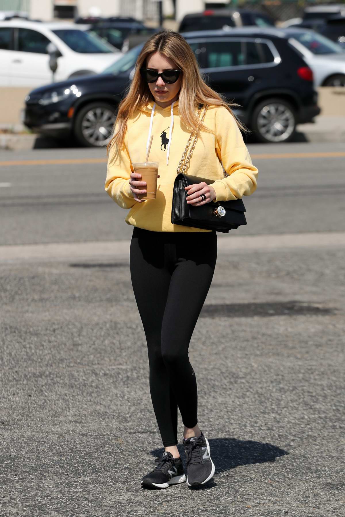 Emma Roberts wears a yellow hoodie and black leggings while out for coffee  in Los Angeles