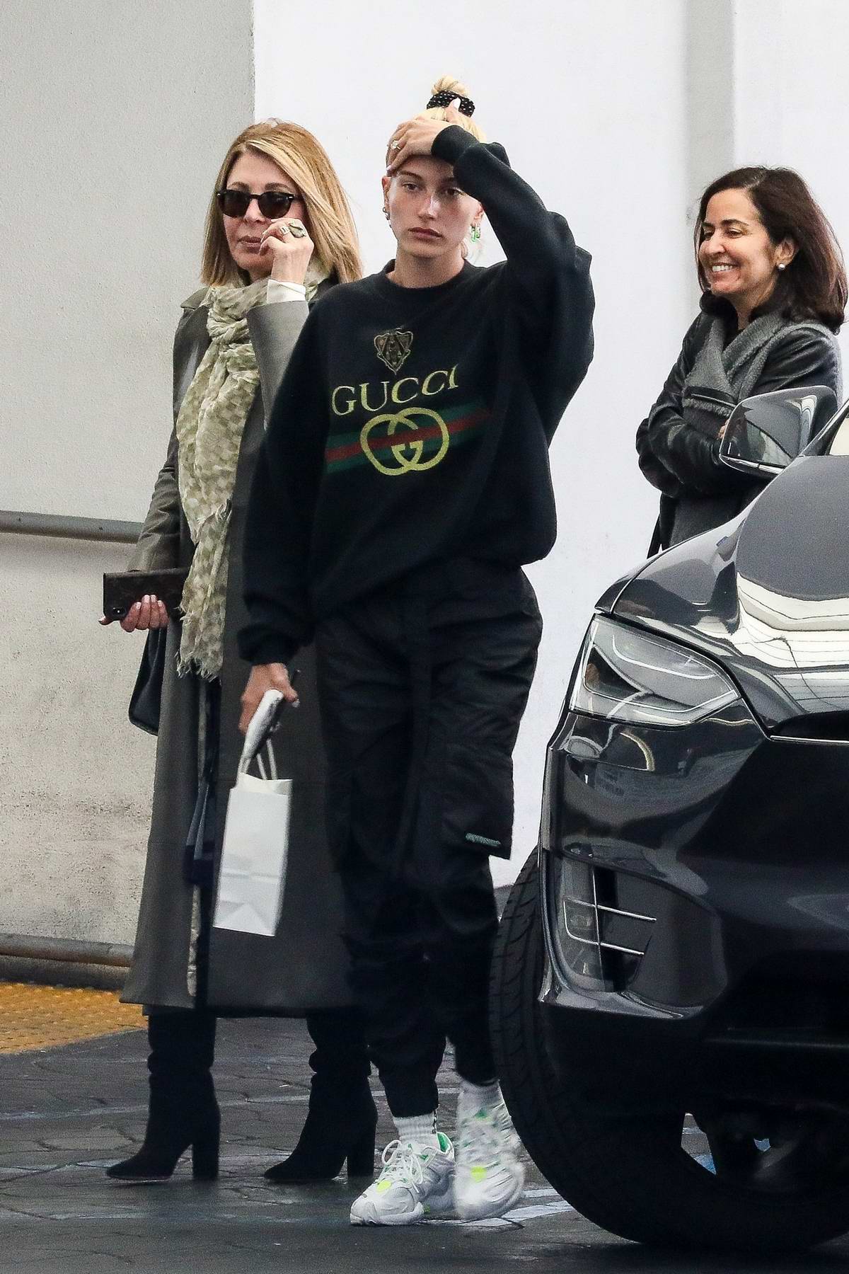 Hailey Baldwin Bieber wearing a Gucci sweatshirt as she leaves