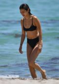 Jamie Chung dons a black bikini as she goes for a quick dip in the ocean in Miami, Florida