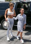 Jennifer Lopez flashes her abs in a white cropped tank top as she heads to the gym with her daughter and sister in Miami, Florida