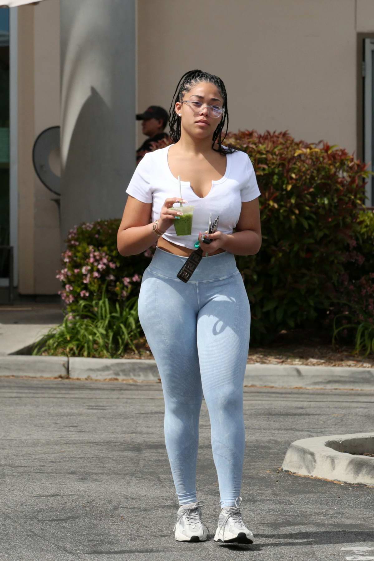 https://www.celebsfirst.com/wp-content/uploads/2019/04/jordyn-woods-sports-a-white-crop-top-and-pastel-blue-leggings-as-she-stops-by-erewhon-market-in-calabasas-los-angeles-090419_5.jpg