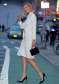 Karlie Kloss looks elegant in a white wrap dress with black heels as she steps out in Manhattan, New York City