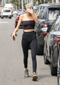 Kendall Jenner shows off her slender figure in a black crop top with  matching leggings during