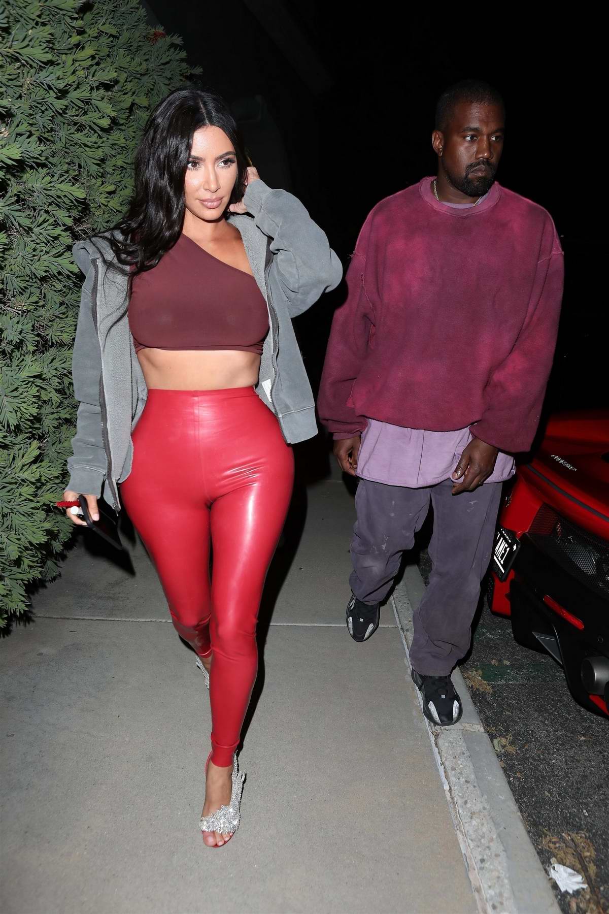kim kardashian dazzles in red pvc leggings with a crop top while out to ...