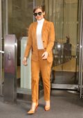 Lauren Cohan looks striking in an orange suit as she leaves an office building in New York City