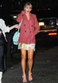 Taylor Swift spotted in a red tweed blazer over a floral mini dress as she returns home from Gigi Hadid's birthday in New York City