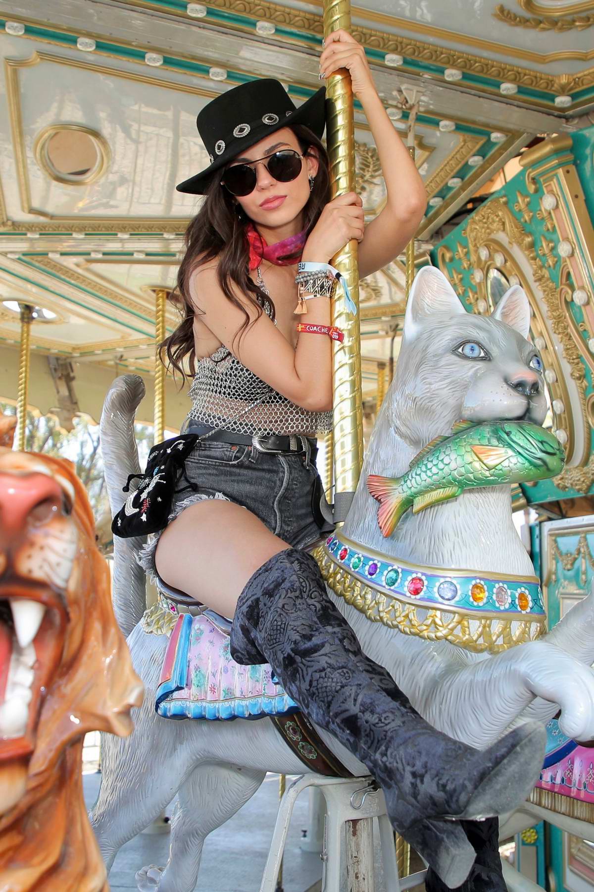 Victoria Justice rocks denim shorts and thigh high boots at the Revolve  Festival during Coachella in