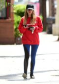 Ashley Benson wears a bright red sweatshirt and blue leggings as she leaves they gym in Studio City, Los Angeles
