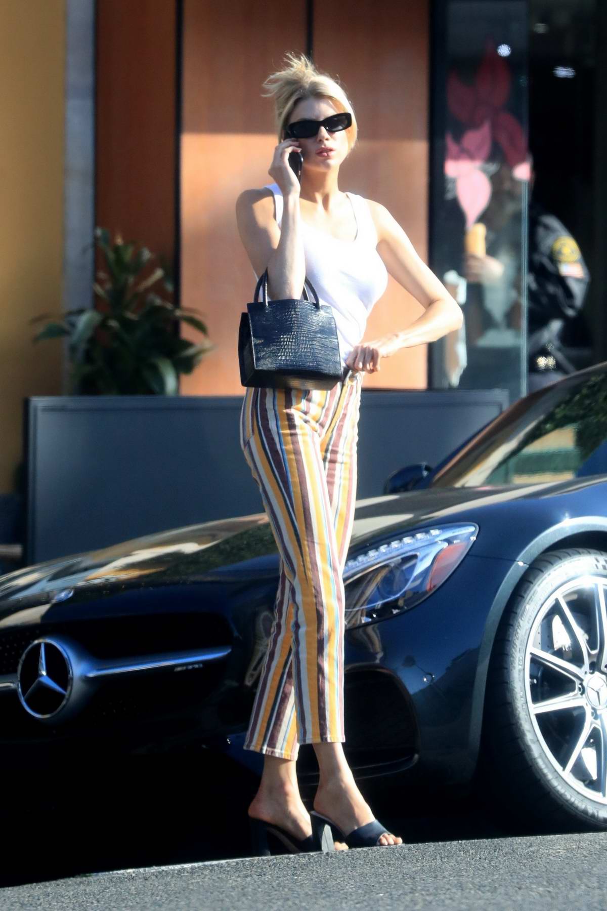 Charlotte Mckinney Looks Lovely In A White Tank Top And Striped Jeans While She Waits For Her 9587