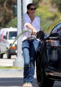 Cindy Crawford spotted in a white blouse and blue jeans as she stops by at a gas station to fill her car in Malibu, California