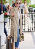 Dakota Fanning seen with her Louis Vuitton suitcase outside the Martinez hotel during the 72nd annual Cannes Film Festival in Cannes, France