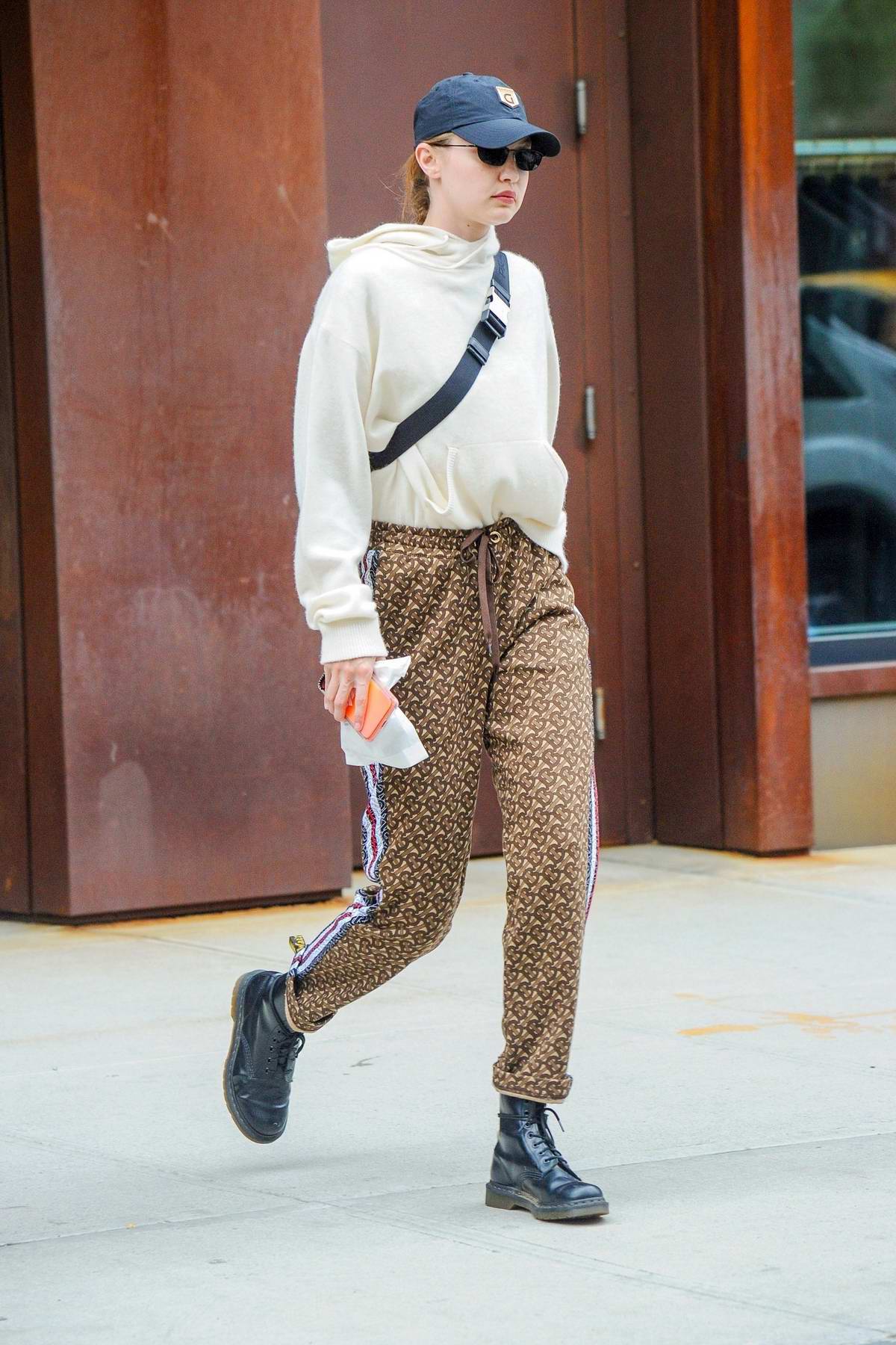 Gigi Hadid looks stylish in a Burberry pants paired with Doc Marten boots  and a Prada