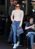 Jennifer Lopez dons form-fitting turtleneck and skinny jeans for a lunch outing with Alex Rodriguez in Miami, Florida