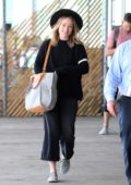 Olivia Wilde is all smiles as she arrives at JFK Airport in New York City