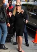 Reese Witherspoon smiles for camera as she arrives for her appearance on 'The Daily Show with Trevor Noah' in New York City