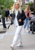 Rita Ora opts for a black leather jacket, white sweatsuit and Nike sneakers as she steps out of the Greenwich Hotel in New York City