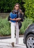 Alessandra Ambrosio keeps it casual chic in black shirt and white jeans as she leaves her home on a moving day in Brentwood, Los Angeles