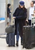 She's no diva! Anne Hathaway happily wheels her own luggage