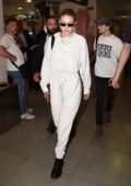 gigi hadid sports white jumpsuit and prada backpack as she arrives at  florence airport, italy-120619_10