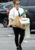Hilary Duff wears a white jacket, black leggings and trainers as she makes a shopping trip to Beverly Hills, Los Angeles