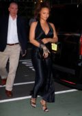 Rihanna looks stunning in a silky black dress as she heads for a private party in New York City