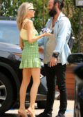 Charlotte McKinney greets a friend as she leaves a party on 4th of July weekend in Malibu, California