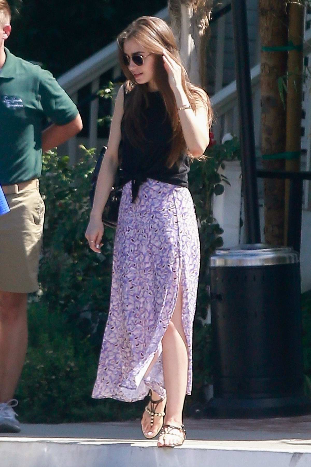 Lily Collins wears a black top and purple skirt for a lunch outing with  friends in