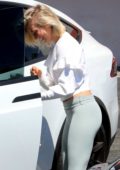 Julianne looks great in a white crop top and light blue leggings as she  steps out