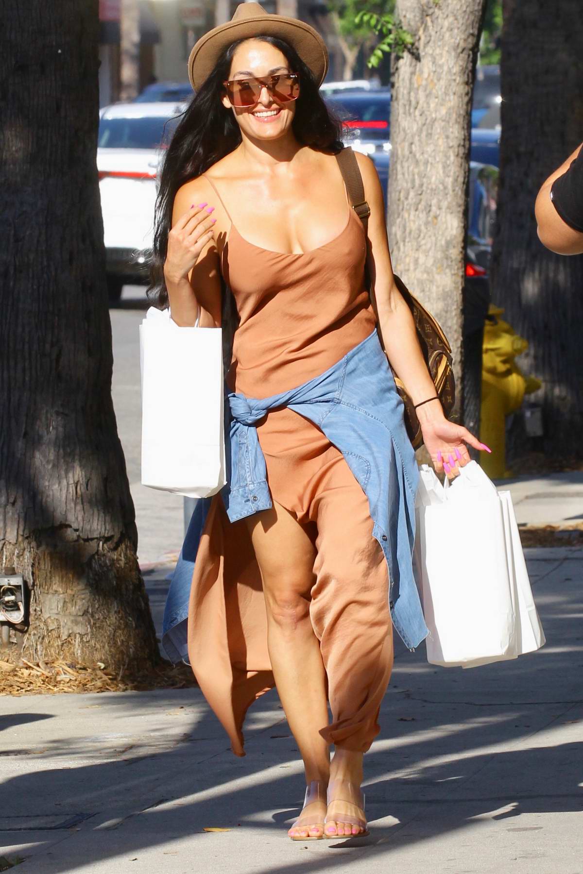 Nikki Bella looks summer chic in a rust colored maxi dress while out for  some shopping