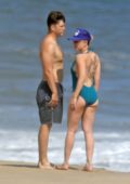 Scarlett Johansson wears an aqua swimsuit while on a romantic beach stroll with Colin Jost in The Hamptons, New York