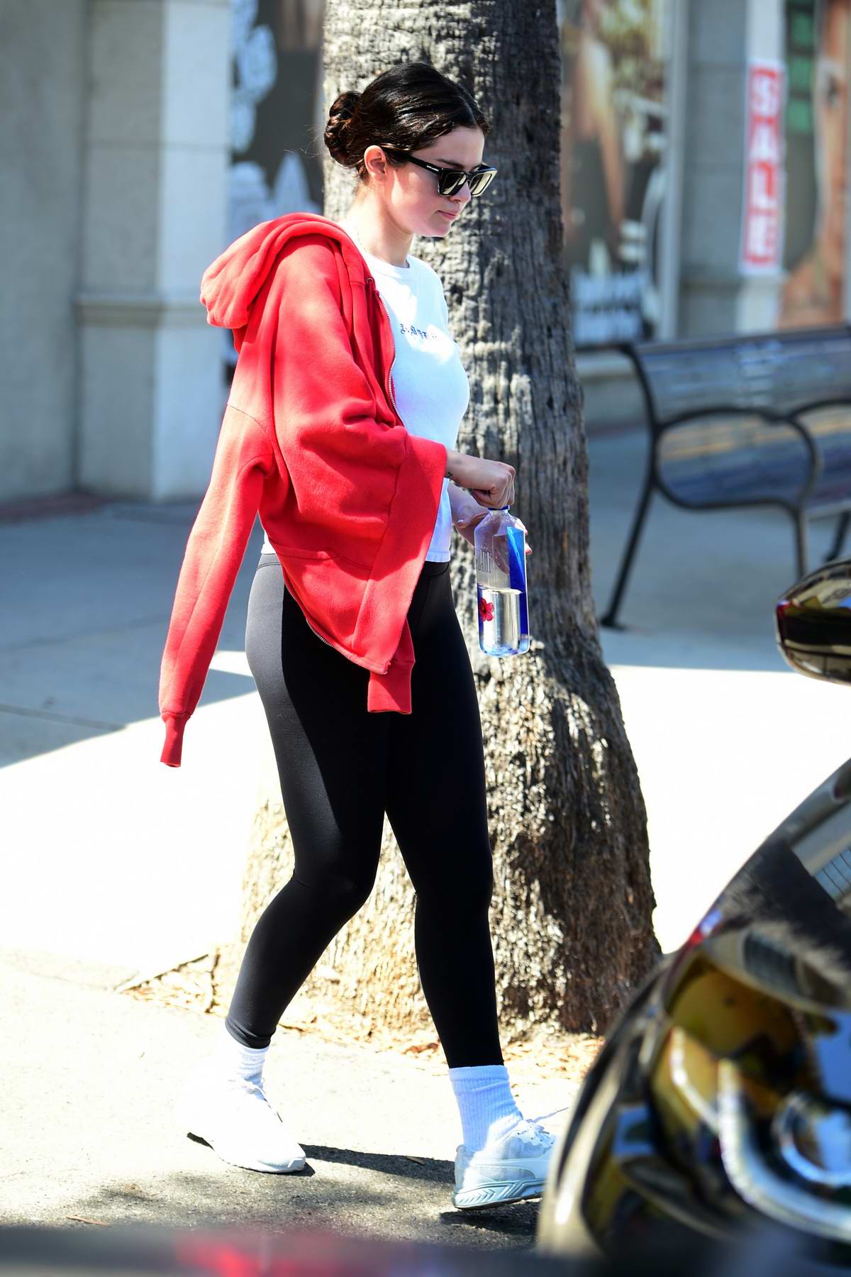 selena gomez looks great in a white top and black leggings as she