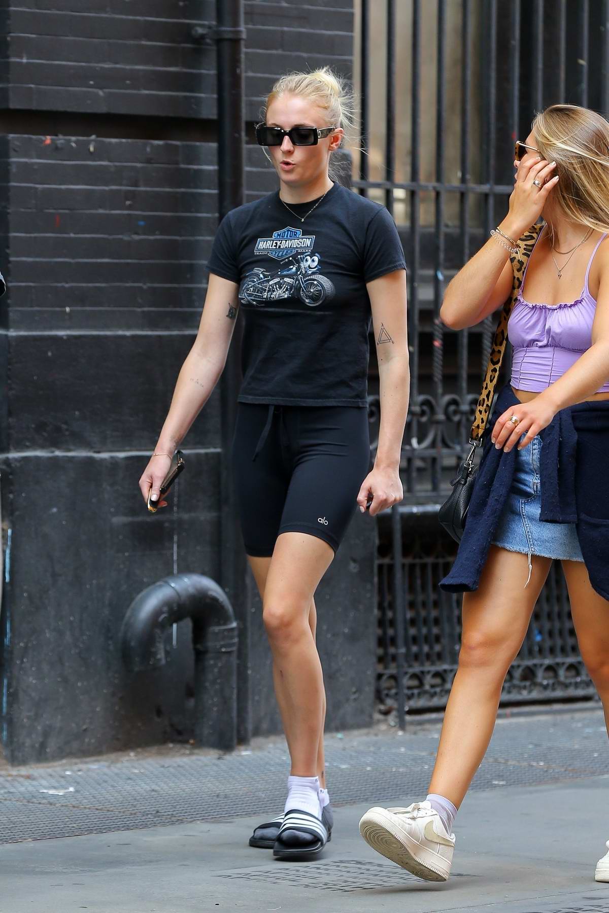 Sophie Turner sports a black Harley Davidson tee and black legging shorts  while out for a