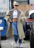 Hailey Baldwin looks stylish in a crop top and trench coat while visiting Manavi Healing Center in Los Angeles