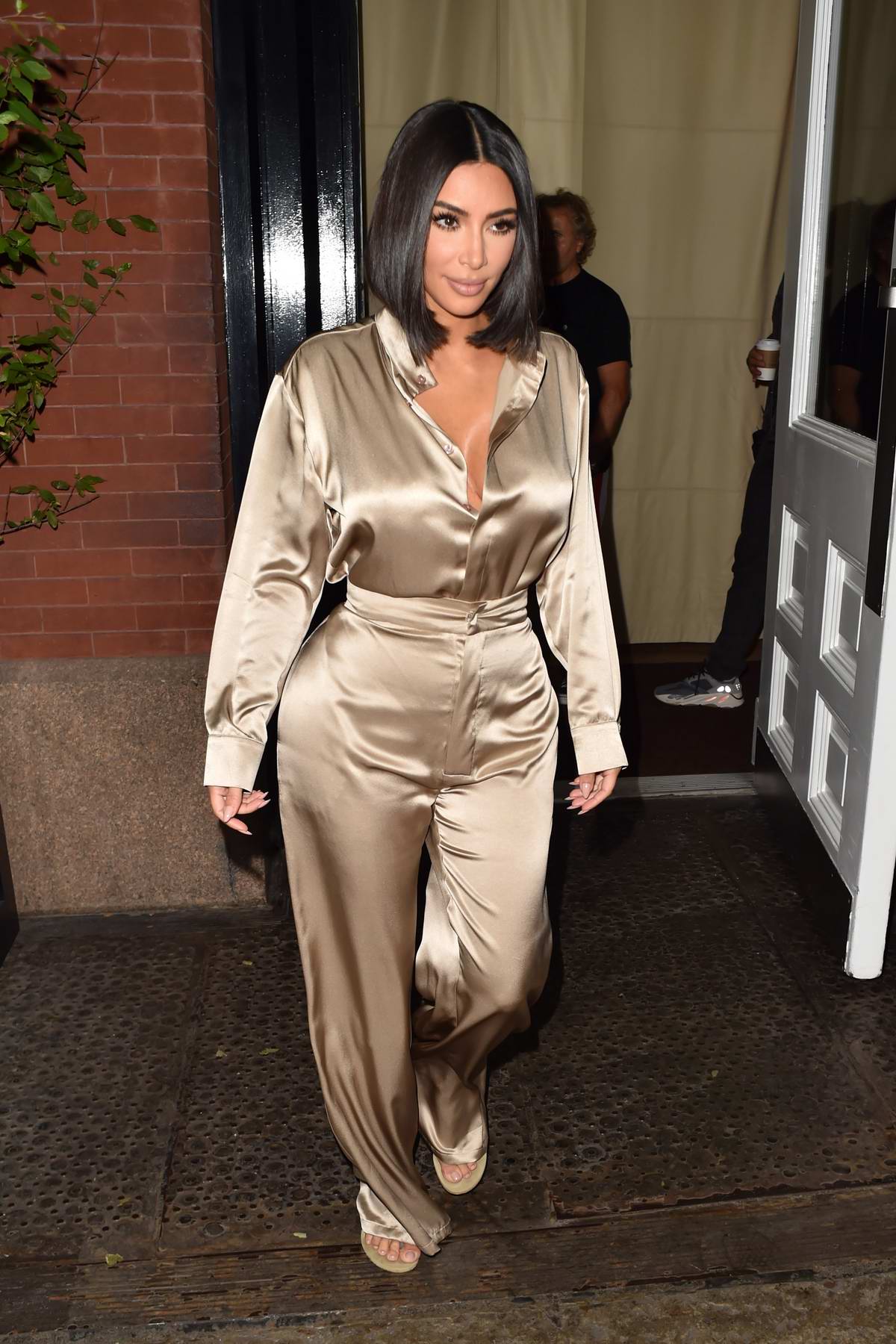 kim kardashian shines in a beige satin ensemble as she leaves the ...