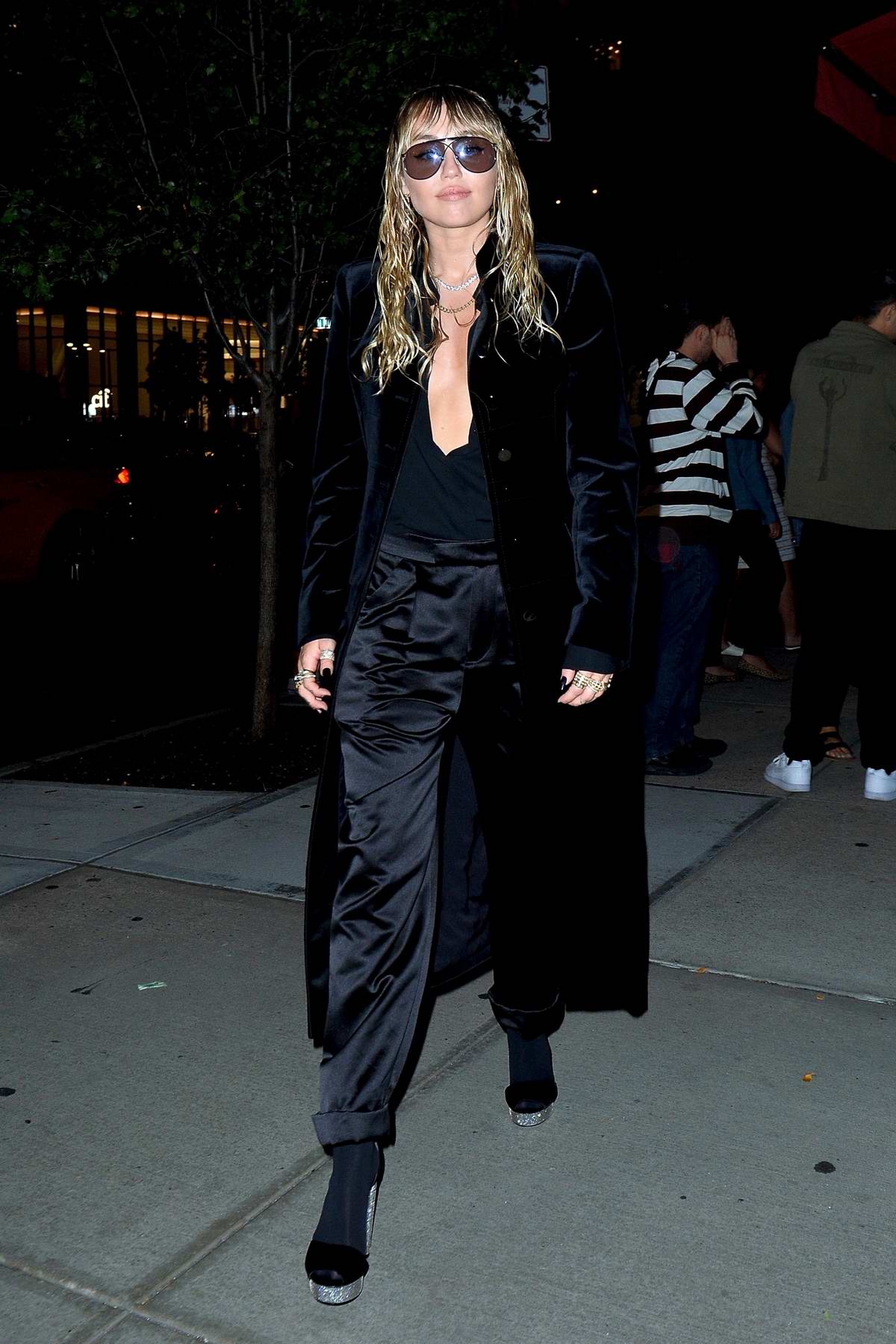 Miley Cyrus dons all-black as she steps out of the Tom Ford Fashion Show  during