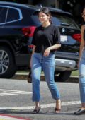 Selena Gomez is all smiles as she carries her pup while out with friends in West Hollywood, Los Angeles