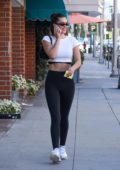 amelia hamlin wears a white crop top and black leggings during a