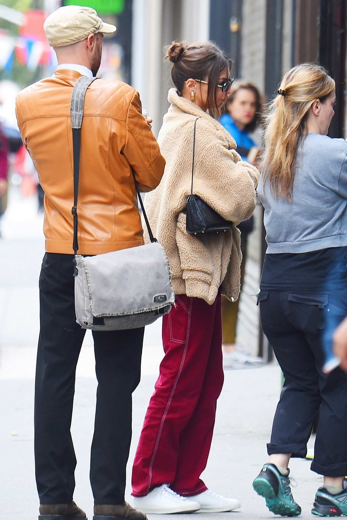 emily ratajkowski wears a beige teddy jacket and red trousers while out ...