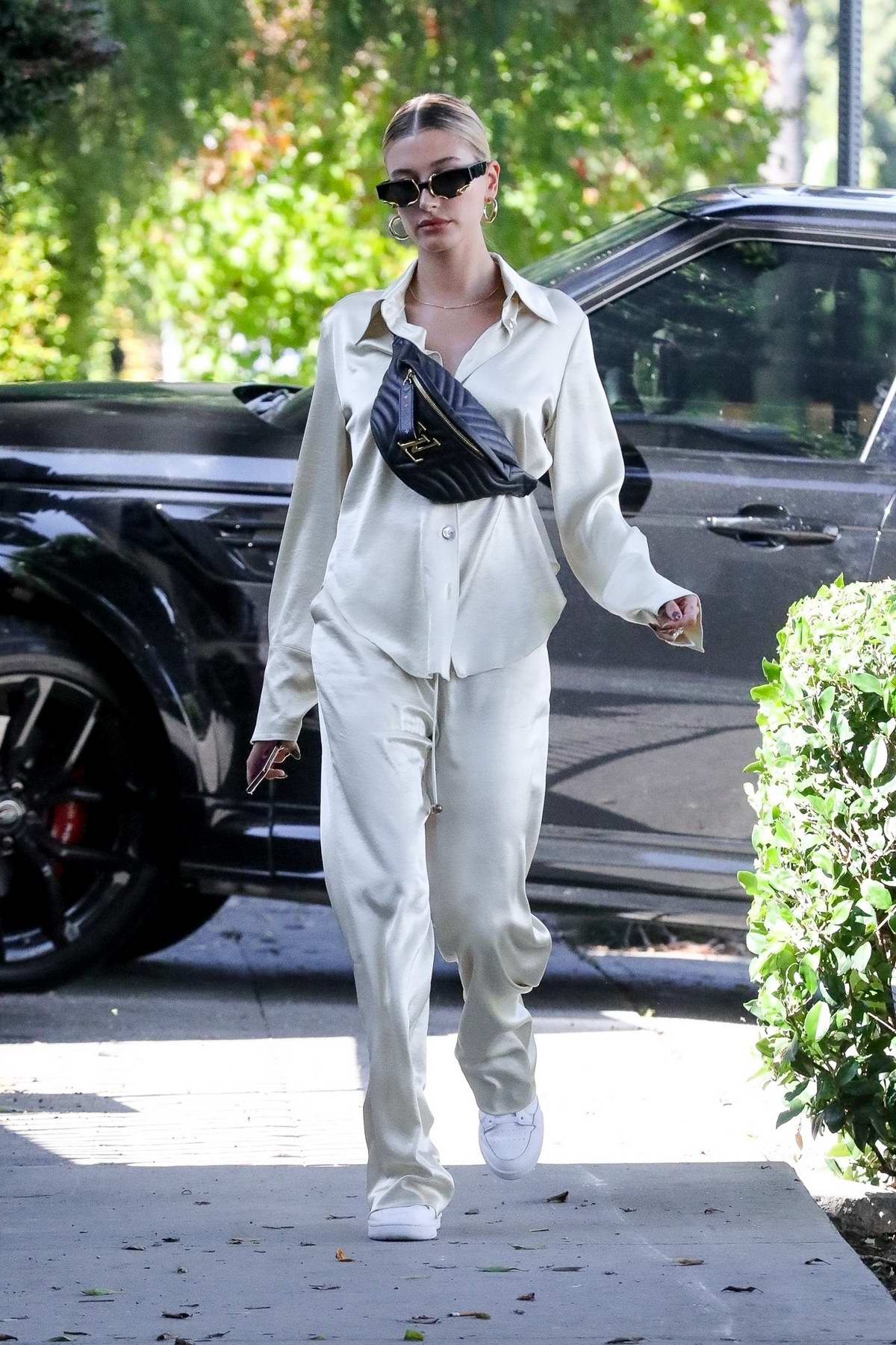 hailey bieber looks casual chic in silk outfit paired with a louis vuitton  fanny pack while out running errands in los angeles-061019_2