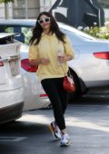 Jenna Dewan wears a yellow hoodie and black leggings as she takes her daughter to Dunkin Donuts in Encino, California