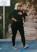 Bebe Rexha sports a cropped black hoodie and leggings as she arrives at a studio in Los Angeles