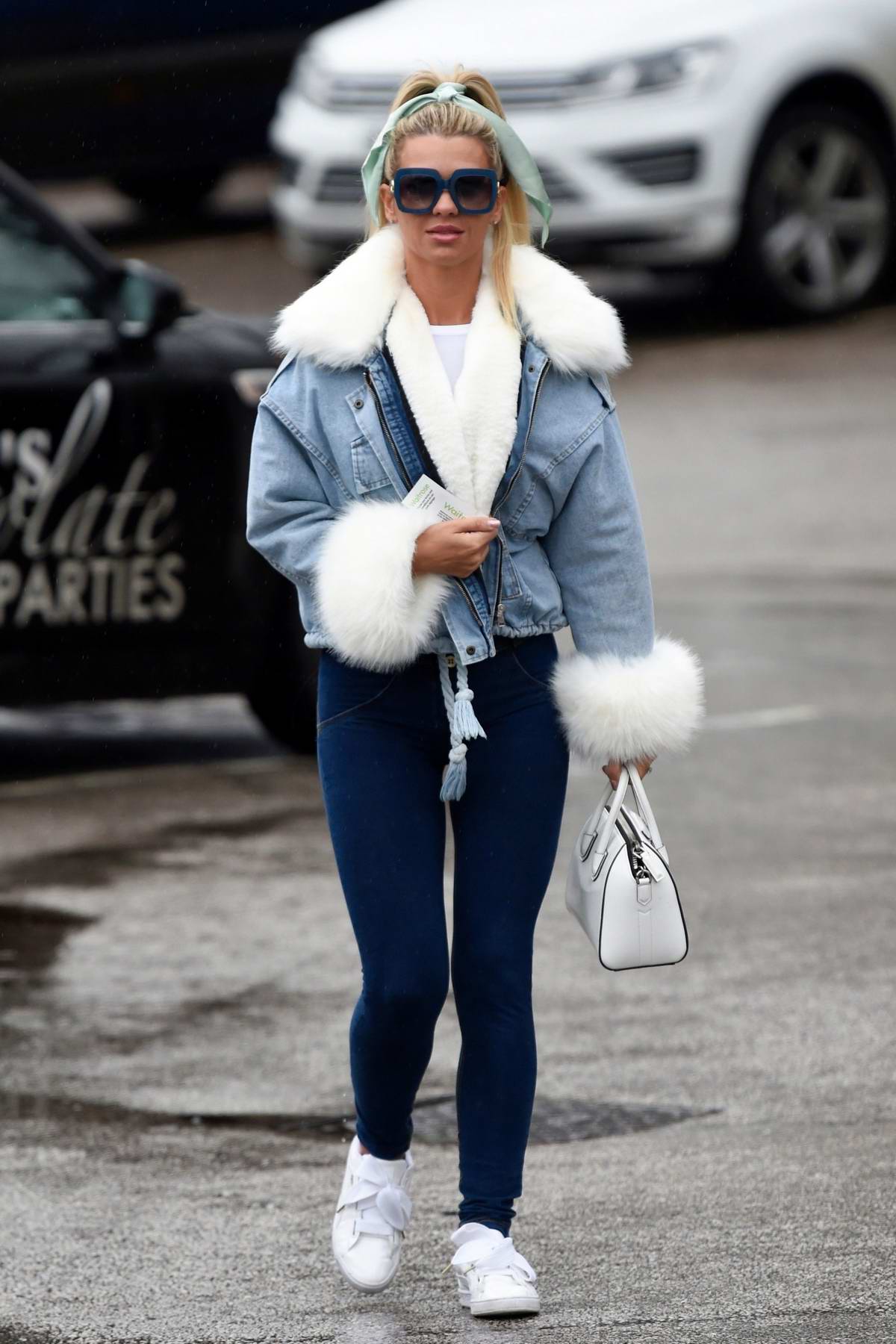 Christine McGuinness seen wearing a fur-lined denim jacket and blue denim  leggings as she steps