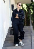 Hailey Bieber looks stylish in a black satin shirt with matching trousers as she leaves an office in Los Angeles