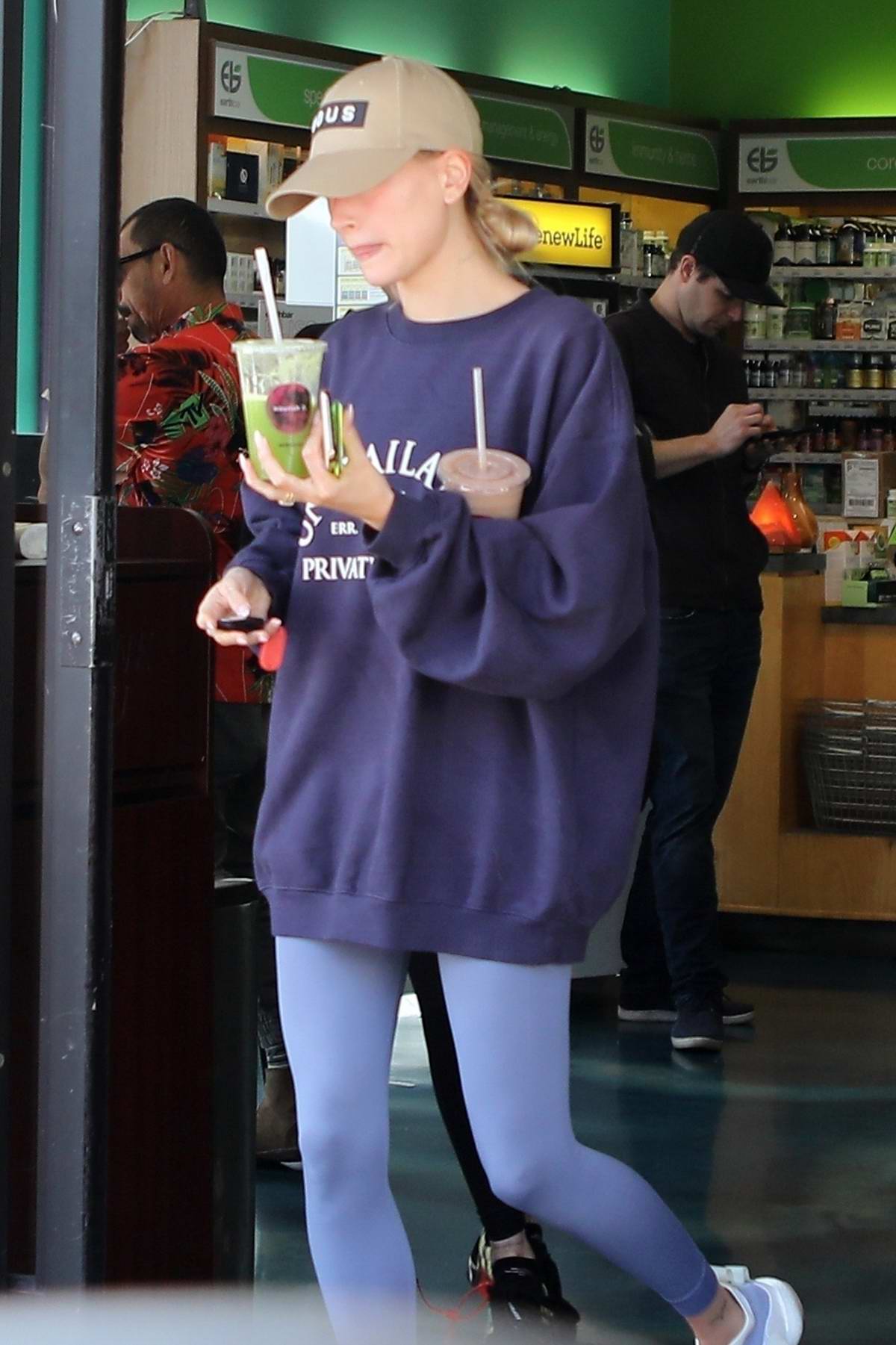 Hailey Bieber rocks a blue sweatshirt and grey leggings as she attends a  hot yoga class