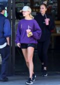 Hailey Bieber rocks a purple sweatshirt and black Nike shorts while out for a smoothie at EarthBar in Los Angeles