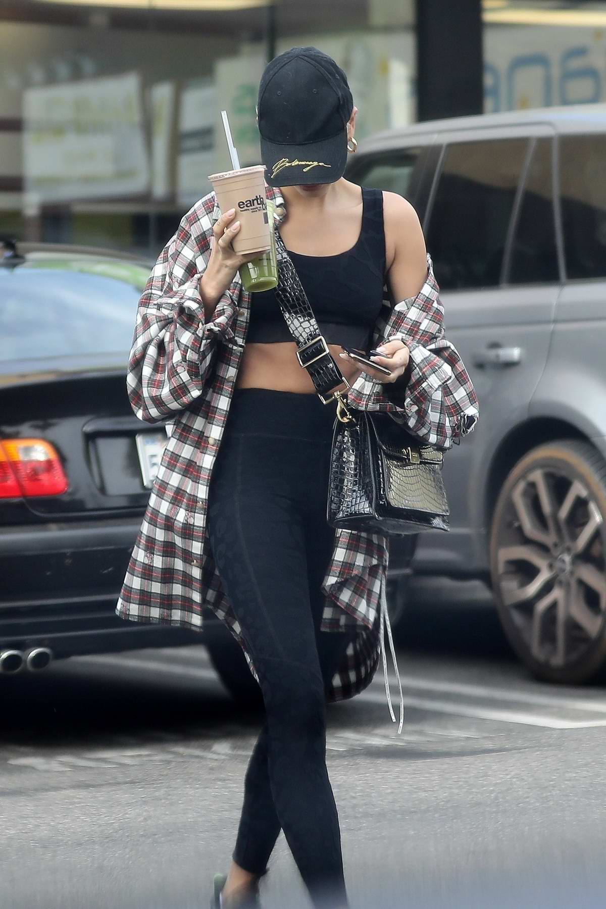 hailey bieber shows off her toned physique in a black sports bra and ...