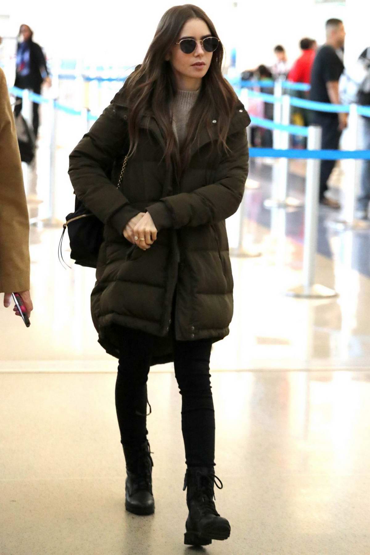 lily collins seen wearing a puffy jacket as she touches down at lax ...
